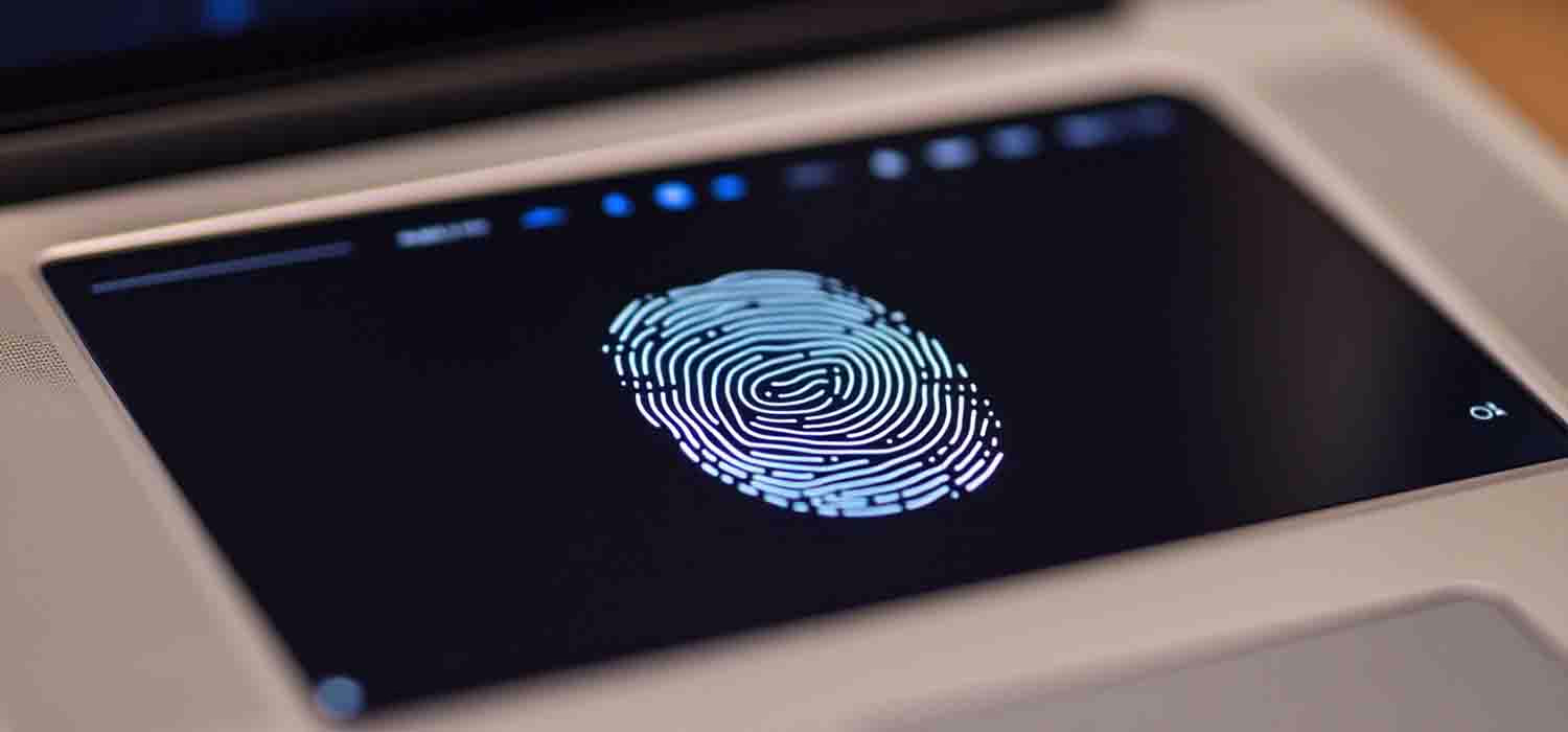 A fingerprint scanner being used for biometric authentication on a laptop